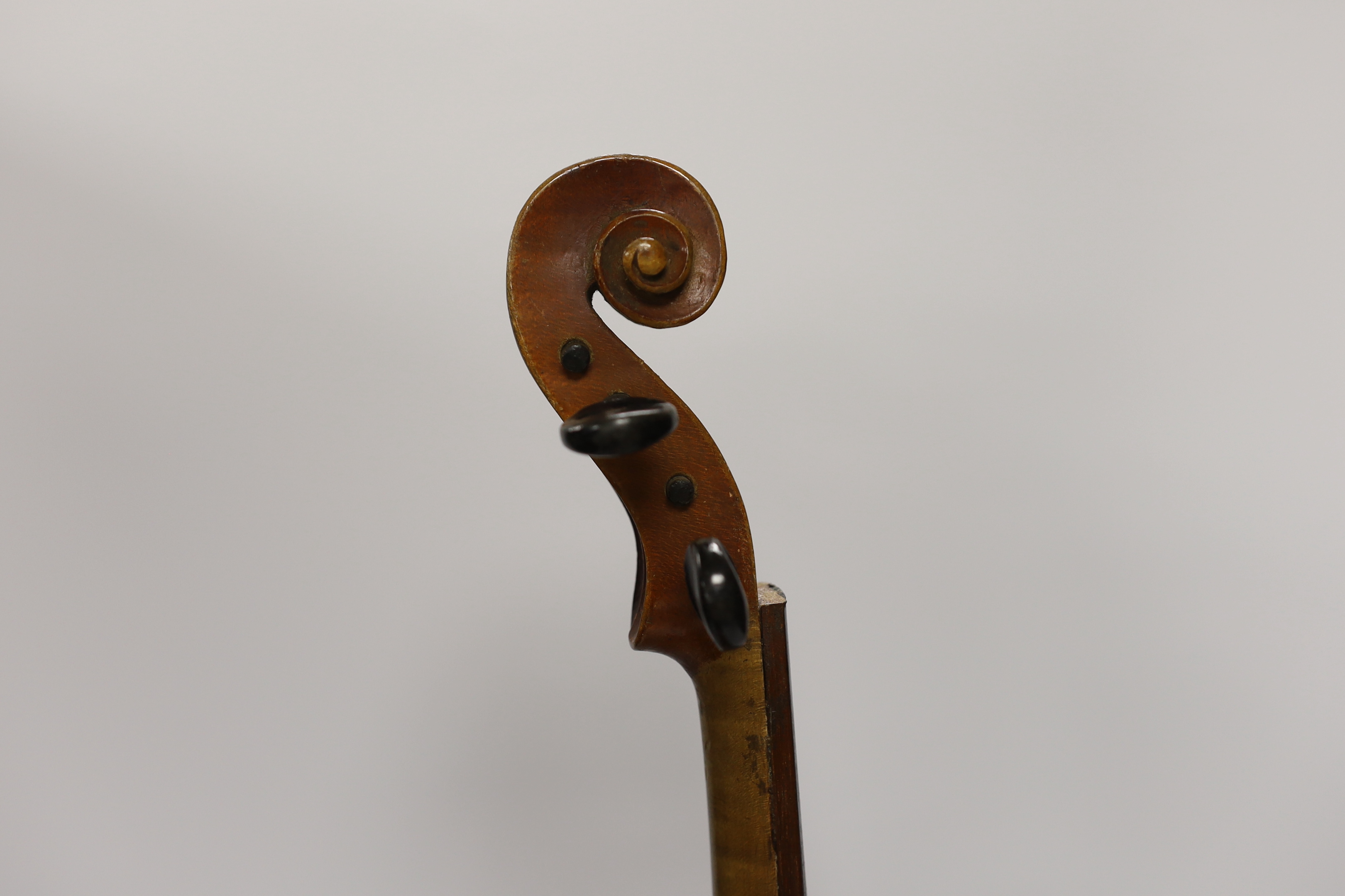 An early twentieth century violin for restoration in an ebonised wooden case, body 36cm (without bow)